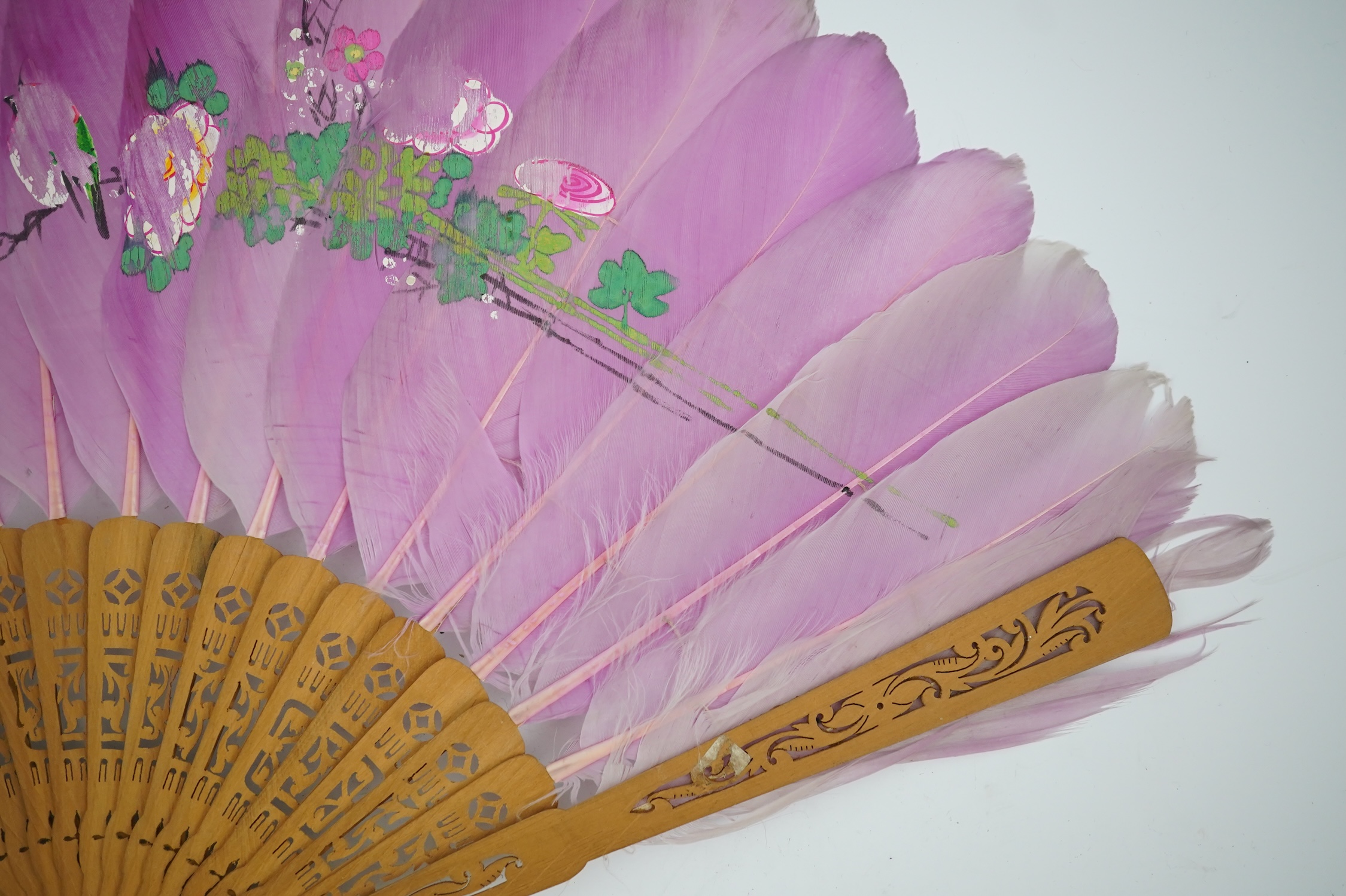 Three 19th century Chinese feather fans: One a carved bone brise black feather fan together with two similar carved sandalwood feather fans, two fans have hand painted decoration on the feathers both sides, the pink feat